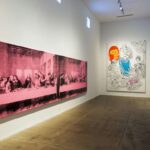 A gallery space displays iconic Andy Warhol artworks, including a pink-toned 'Last Supper' and a vibrant piece featuring the number '69', symbolizing the artist's influence on pop art.