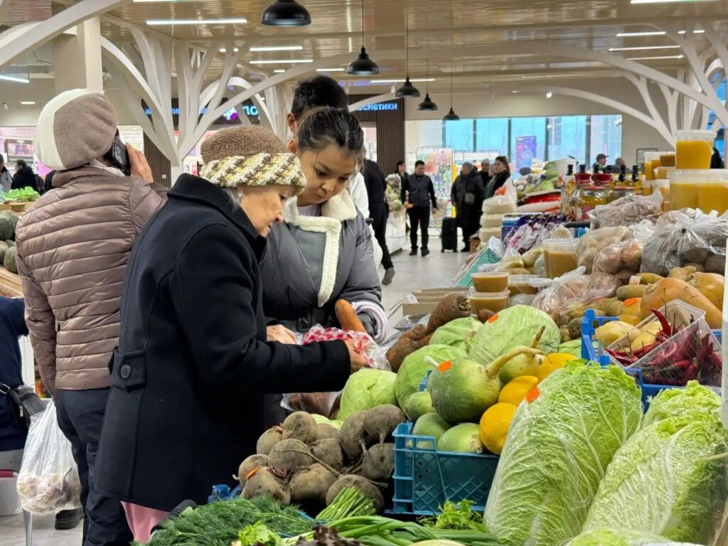 Shoppers in a Central Asian grocery store reflect the economic pressures affecting daily life as the ruble's collapse ripples through the region.
