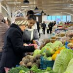 Shoppers in a Central Asian grocery store reflect the economic pressures affecting daily life as the ruble's collapse ripples through the region.