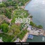 A serene aerial view of a riverside park in Sofia, contrasting with the city's recent anti-corruption protests demanding justice for businessman Pevski.