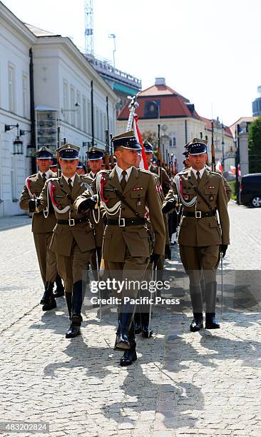 Polish troops march in formation through the historic streets of Warsaw, symbolizing national pride and the strength of NATO's eastern flank.